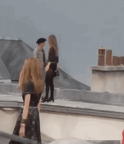 A gif of Gigi Hadid escorting someone off of the Chanel runway at Paris Fashion Week.