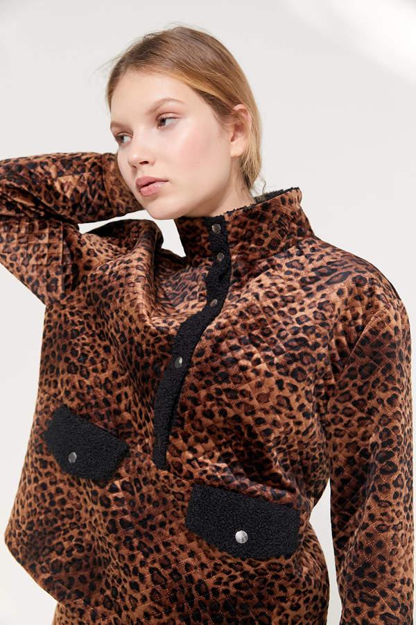 A model wearing a leather print sherpa jacket from Urban Outfitters.